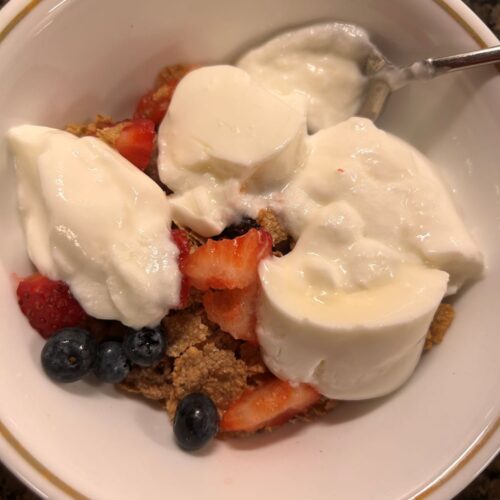 Yogurt with oats, granola, bran flakes blueberries and strawberries