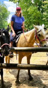 Nancy Dru riding a horse at a state park.