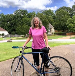 Nancy Dru standing behind her 30 plus year old bike.