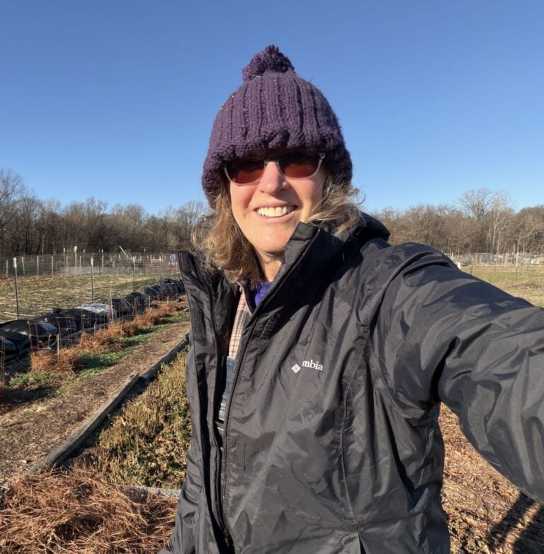 Nancy with her blueberries in the distance on the left side.