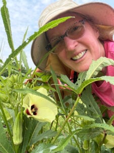 Nancy with her okra plants
