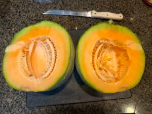 cut cantaloupe showing seeds and inside pulp